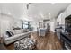 Open-concept living space with kitchen island, modern lighting, and access to the outdoor patio at 4581 S Kipling Cir, Denver, CO 80123