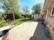 Backyard with a concrete patio, storage shed, lawn, and privacy fence at 3531 E 91St Ave, Thornton, CO 80229