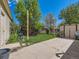 This backyard features a shed, concrete patio, grass, and fence at 3531 E 91St Ave, Thornton, CO 80229