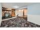 Basement space featuring a stone fireplace, carpeted floors, and neutral wall colors at 3531 E 91St Ave, Thornton, CO 80229
