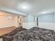 Finished basement space with paneling, carpeted floors, and convenient laundry area at 3531 E 91St Ave, Thornton, CO 80229