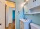 Bright bathroom with a modern vanity, medicine cabinet and patterned wallpaper at 3531 E 91St Ave, Thornton, CO 80229