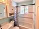 Charming bathroom featuring a tiled shower/tub combo and built-in storage at 3531 E 91St Ave, Thornton, CO 80229