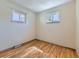 Empty bedroom with hardwood flooring, neutral walls and sunlit double windows at 3531 E 91St Ave, Thornton, CO 80229