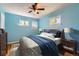 Bedroom with blue walls and a cozy bed, accented by dual windows and side tables at 3531 E 91St Ave, Thornton, CO 80229