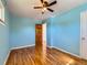 A blue bedroom with hardwood flooring, a ceiling fan, and dual closets at 3531 E 91St Ave, Thornton, CO 80229