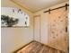 Dining area featuring wood floors, sliding barn door and charming archway to kitchen at 3531 E 91St Ave, Thornton, CO 80229