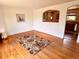 Open dining room with hardwood floors, rug, and view to kitchen through archway at 3531 E 91St Ave, Thornton, CO 80229