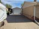 A long driveway leading to a detached garage in the backyard at 3531 E 91St Ave, Thornton, CO 80229