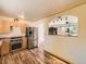 Kitchen with stainless steel appliances, wood cabinets, and view to the dining area at 3531 E 91St Ave, Thornton, CO 80229