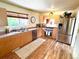 Modern kitchen with stainless steel appliances, light wood cabinets, and laminate flooring at 3531 E 91St Ave, Thornton, CO 80229
