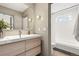 Modern bathroom featuring a floating vanity, sleek fixtures, and a combined shower-tub at 3270 S Washington St, Englewood, CO 80113