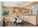 Cozy dining area with modern light fixture adjacent to a kitchen with wood paneling detail at 3270 S Washington St, Englewood, CO 80113