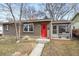 Charming home featuring a bright red front door, neutral stucco, and mature trees in a cozy front yard at 3270 S Washington St, Englewood, CO 80113