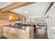 Modern kitchen featuring stainless steel countertops, wood cabinetry, and an open layout concept to the living space at 3270 S Washington St, Englewood, CO 80113