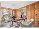 Bright sunroom with wood paneling, ample natural light, and cozy seating space for relaxation or work at 3270 S Washington St, Englewood, CO 80113