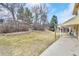 Backyard view highlighting a large lawn area with mature trees and natural landscaping at 10627 Chautauga Mtn, Littleton, CO 80127