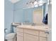 A well-lit bathroom with a neutral-toned vanity, a commode, and a large mirror, exuding a clean and inviting ambiance at 10627 Chautauga Mtn, Littleton, CO 80127