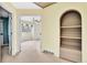 View of the hallway leading to a bedroom with built in shelving and neutral carpeting at 10627 Chautauga Mtn, Littleton, CO 80127