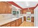 Charming kitchen with wooden cabinetry, white appliances, and a window overlooking the backyard, creating a cozy atmosphere at 10627 Chautauga Mtn, Littleton, CO 80127