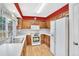 Traditional kitchen featuring wooden cabinets, white appliances, and a large window offering natural light at 10627 Chautauga Mtn, Littleton, CO 80127