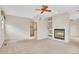 A comfortable living room with a fireplace and a built in shelving unit with neutral carpeting at 10627 Chautauga Mtn, Littleton, CO 80127
