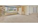 Bright living room featuring a large window with a built-in bench and ample shelving for storage and display at 10627 Chautauga Mtn, Littleton, CO 80127