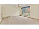 Spacious living room boasts natural light through a large window, with neutral walls and carpet ready for customization at 10627 Chautauga Mtn, Littleton, CO 80127