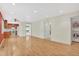 Open-concept living space with hardwood floors and recessed lighting, seamlessly connecting to the kitchen and laundry area at 10627 Chautauga Mtn, Littleton, CO 80127