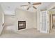 Spacious living room featuring a fireplace, ceiling fan, and a doorway to the hallway at 10627 Chautauga Mtn, Littleton, CO 80127