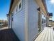 Spacious balcony with gray siding and a modern railing perfect for entertaining or relaxing outdoors at 46554 Avery Ln, Bennett, CO 80022