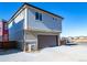Modern gray two-story home with a front garage and clean, simple landscaping at 46554 Avery Ln, Bennett, CO 80022