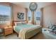 Cozy bedroom with large windows, stylish lighting, and a comfortable bed with striped pillows at 8437 Mount Kataka Loop, Littleton, CO 80125