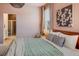 Stylish bedroom with a bathroom, wooden bed frame, bedside tables, and striped pillows at 8437 Mount Kataka Loop, Littleton, CO 80125