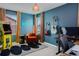 Modern bedroom boasts an arcade game, guitars, a chair, and a dedicated desk area at 8437 Mount Kataka Loop, Littleton, CO 80125