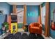 Charming bedroom featuring stylish decor, an arcade game, and a comfortable chair at 8437 Mount Kataka Loop, Littleton, CO 80125