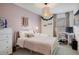 This stylish bedroom features a white metal frame bed, a desk, and pretty pink accents at 8437 Mount Kataka Loop, Littleton, CO 80125