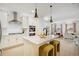 Bright, modern kitchen with white cabinets, stainless steel appliances, and a large island with seating at 8437 Mount Kataka Loop, Littleton, CO 80125