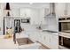 Bright and airy kitchen featuring modern appliances, white cabinetry, and stylish finishes for a chic, functional space at 8437 Mount Kataka Loop, Littleton, CO 80125