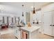 Contemporary kitchen with a center island, stainless steel appliances, and views into the living space at 8437 Mount Kataka Loop, Littleton, CO 80125