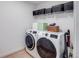 Functional laundry room featuring modern washer and dryer, and storage shelves at 8437 Mount Kataka Loop, Littleton, CO 80125