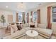 Bright living room and dining space with a large sectional sofa and decorative accents at 8437 Mount Kataka Loop, Littleton, CO 80125