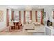 Sunlit living room and dining area with stylish furnishings and large windows offering natural light at 8437 Mount Kataka Loop, Littleton, CO 80125