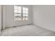 Bright bedroom featuring plush carpet, two windows for natural light, and neutral walls at 8887 San Antonio St, Littleton, CO 80125