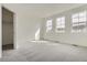 Spacious bedroom with plush carpet, three windows for natural light, and neutral walls at 8887 San Antonio St, Littleton, CO 80125