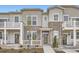 Attractive townhome showcasing stone accents, covered porch and landscaped front yard at 8887 San Antonio St, Littleton, CO 80125