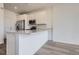 Stylish kitchen with white cabinets, stainless steel appliances, and quartz countertops at 8887 San Antonio St, Littleton, CO 80125