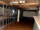 Unfinished basement with exposed framing, water tank, and wiring ready for renovation at 241 W 4Th Ave, Denver, CO 80223