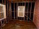 Unfinished bedroom ready to be customized featuring exposed studs, brick wall, and a window at 241 W 4Th Ave, Denver, CO 80223