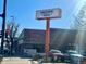 Daytime shot of Punch Bowl Social, showing its sign, brick facade, and surrounding streetscape at 241 W 4Th Ave, Denver, CO 80223